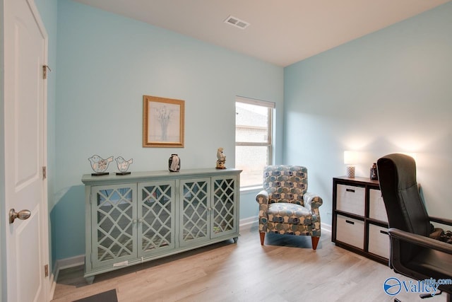 home office with visible vents, baseboards, and light wood finished floors