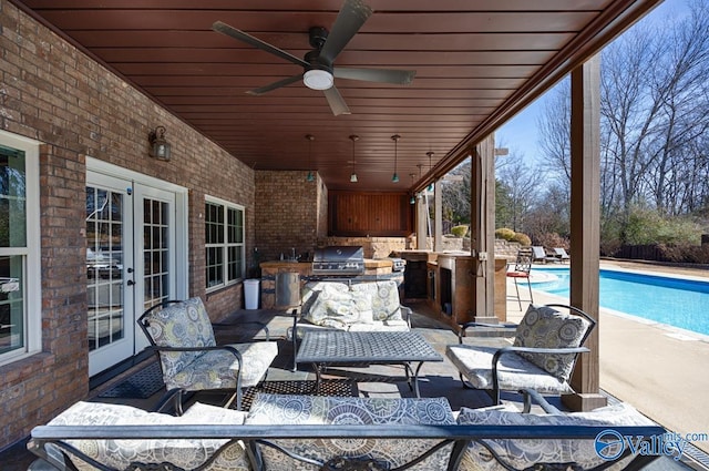 view of patio with an outdoor pool, an outdoor kitchen, area for grilling, french doors, and an outdoor living space