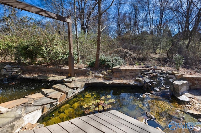 exterior space with a garden pond