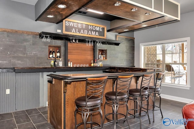 bar featuring dark tile patterned floors