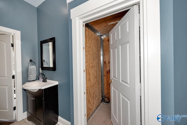 bathroom featuring baseboards and vanity