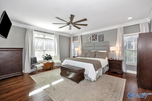 bedroom featuring baseboards, wood finished floors, a ceiling fan, and crown molding