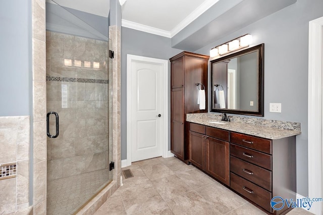 bathroom featuring ornamental molding, baseboards, a shower stall, and vanity