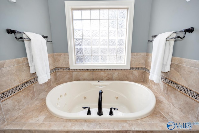 bathroom with a tub with jets and a wealth of natural light