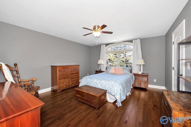 bedroom featuring ceiling fan, baseboards, and wood finished floors