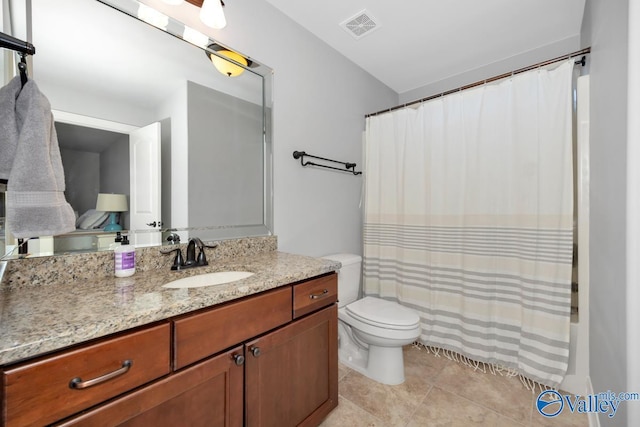 bathroom with visible vents, a shower with shower curtain, toilet, tile patterned floors, and vanity