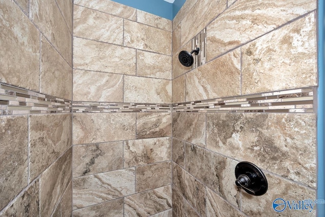 interior details with a tile shower