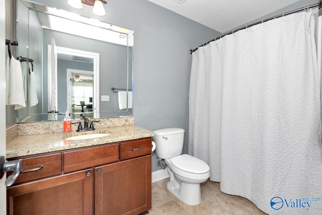 full bath featuring toilet, vanity, baseboards, and tile patterned floors