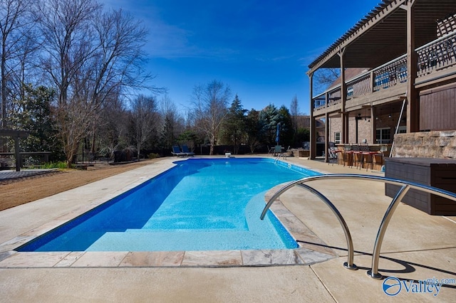 pool featuring outdoor dry bar and a patio