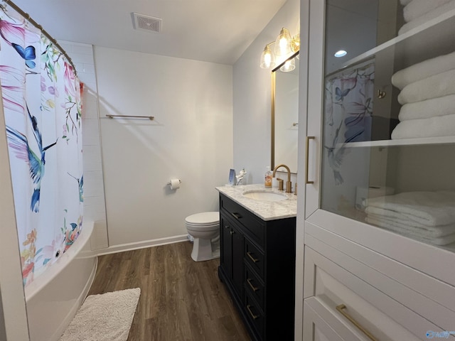 full bathroom with hardwood / wood-style flooring, vanity, toilet, and shower / bath combination with curtain