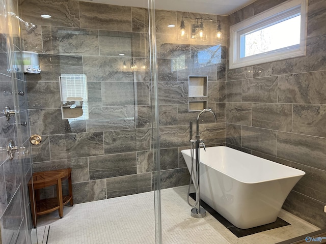 bathroom featuring plus walk in shower and tile walls