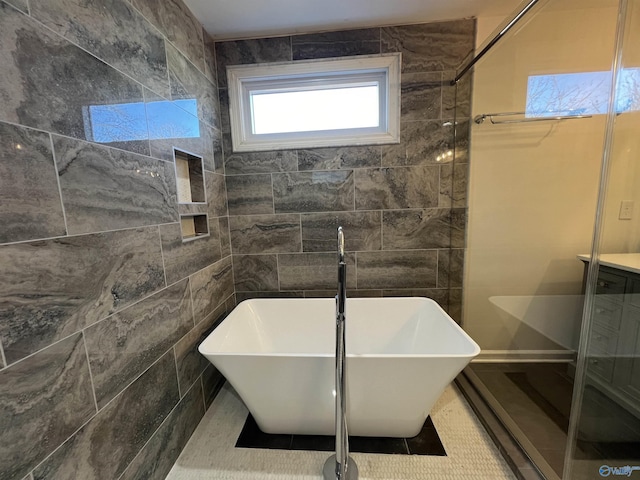 bathroom with plus walk in shower and tile walls