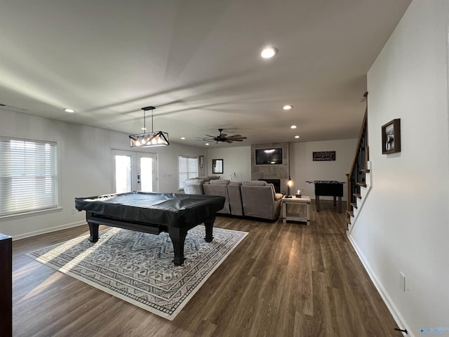 game room featuring dark wood-type flooring, ceiling fan, a fireplace, pool table, and french doors