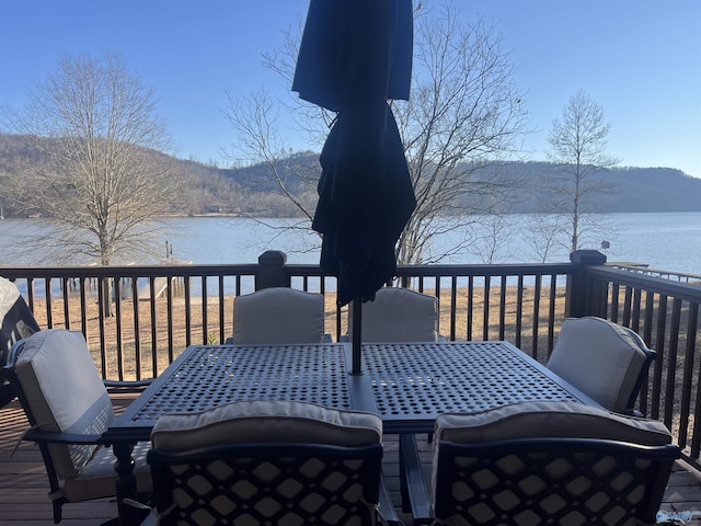 wooden deck featuring a water and mountain view