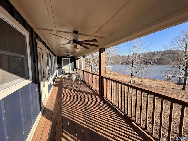 wooden terrace featuring a water view and ceiling fan