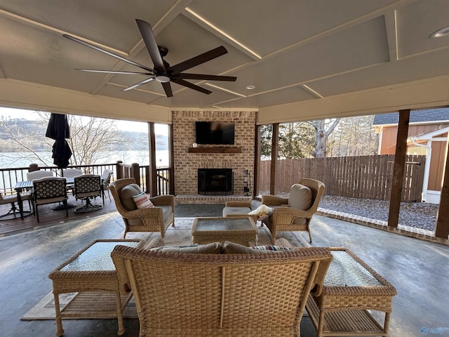 view of patio featuring an outdoor brick fireplace and ceiling fan