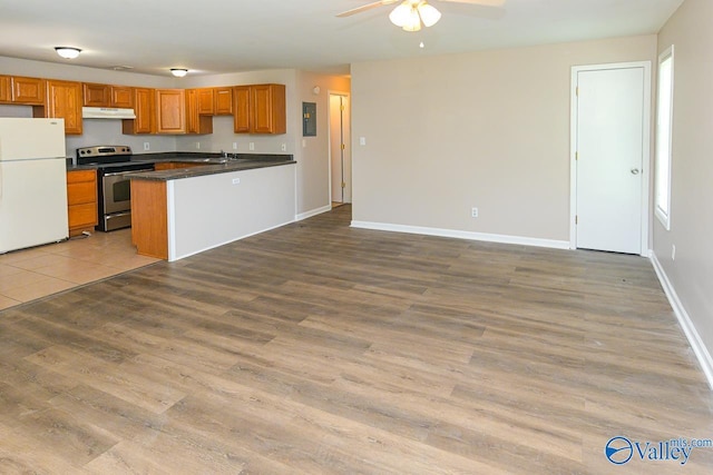 4114 Triana Blvd, Huntsville, AL 35802 - kitchen featuring freestanding refrigerator, stainless steel range with electric cooktop, ceiling fan, dark countertops, and wood finished floors