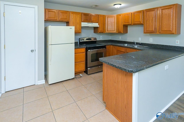 4114 Triana Blvd, Huntsville, AL 35802 - kitchen featuring freestanding refrigerator, stainless steel electric stove, under cabinet range hood, and brown cabinets