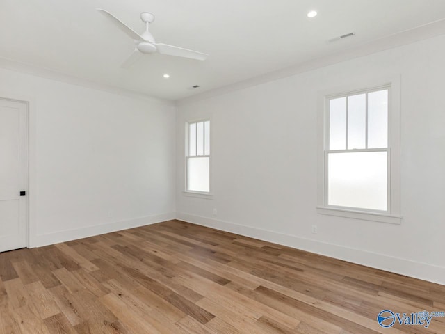 unfurnished room with ornamental molding, ceiling fan, and light wood-type flooring