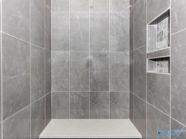 bathroom with a tile shower