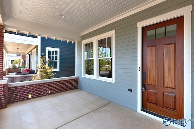 view of exterior entry with a porch