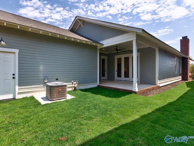 back of house with cooling unit, a lawn, ceiling fan, and a patio area