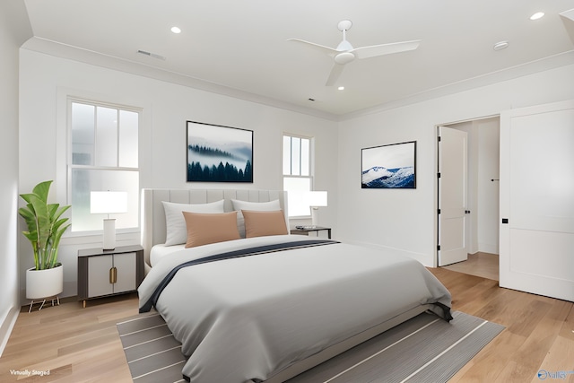 bedroom featuring ornamental molding, ceiling fan, and light hardwood / wood-style flooring