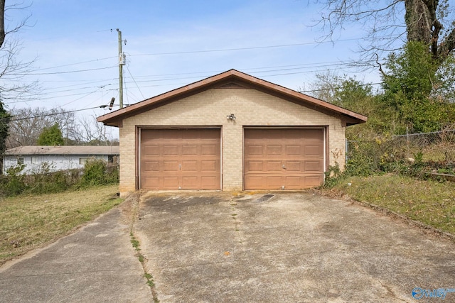 detached garage featuring fence