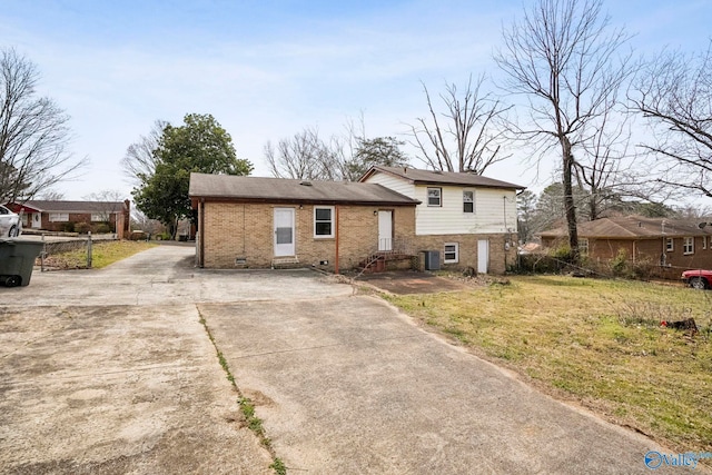 split level home with brick siding, crawl space, cooling unit, and entry steps