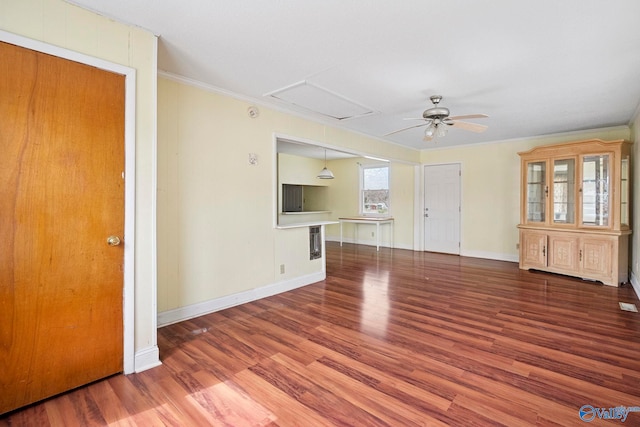 unfurnished living room with a ceiling fan, crown molding, wood finished floors, and baseboards