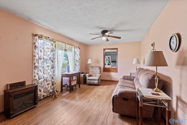 26740 Nick Davis Rd, Athens, AL 35613 - living area featuring a textured ceiling, ceiling fan, wood finished floors, and baseboards