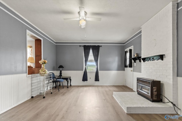 26740 Nick Davis Rd, Athens, AL 35613 - interior space featuring ceiling fan, a wainscoted wall, heating unit, ornamental molding, and wood finished floors