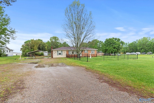 26740 Nick Davis Rd, Athens, AL 35613 - manufactured / mobile home featuring a chimney, fence, dirt driveway, a detached carport, and a front lawn
