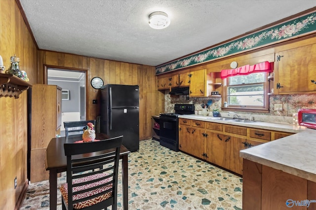 26740 Nick Davis Rd, Athens, AL 35613 - kitchen featuring under cabinet range hood, light countertops, brown cabinets, black appliances, and a sink