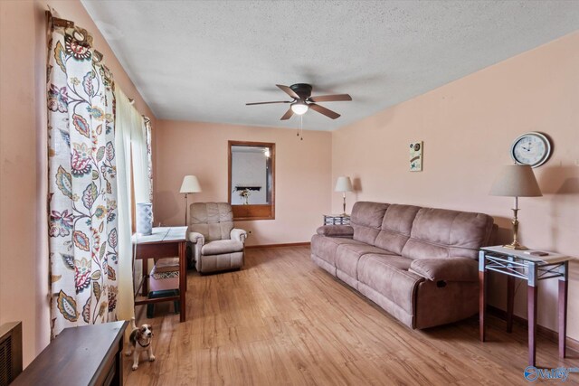 26740 Nick Davis Rd, Athens, AL 35613 - living room with a textured ceiling, ceiling fan, wood finished floors, and baseboards