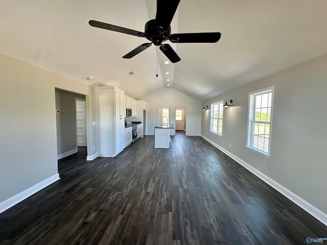 unfurnished living room with dark hardwood / wood-style flooring, ceiling fan, and lofted ceiling