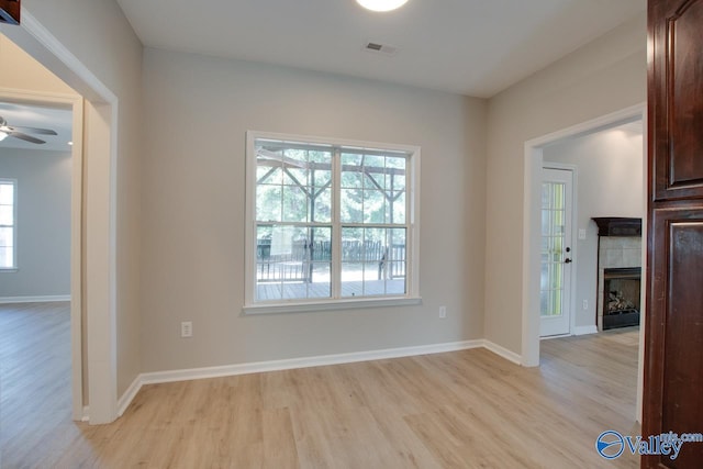 unfurnished dining area with visible vents, a ceiling fan, light wood-style floors, and plenty of natural light