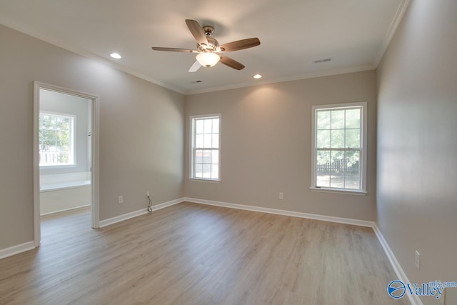 spare room with crown molding, visible vents, ceiling fan, and light wood-type flooring