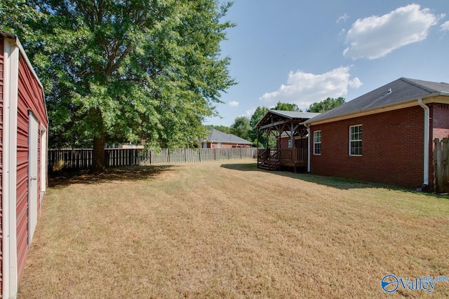 view of yard featuring a deck, a gazebo, and a fenced backyard