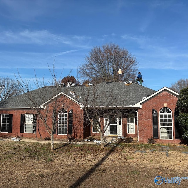 single story home with brick siding and roof with shingles