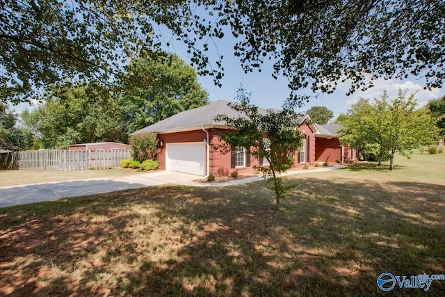 view of front facade with brick siding, fence, driveway, a front yard, and an attached garage