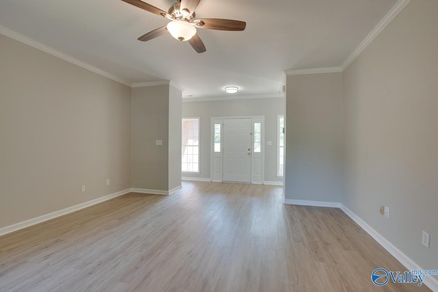 interior space featuring ornamental molding, a ceiling fan, baseboards, and light wood-type flooring