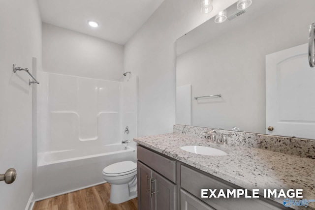 297 Keller Dr, Hazel Green, AL 35750 - bathroom with toilet, wood finished floors, visible vents, vanity, and shower / bathing tub combination