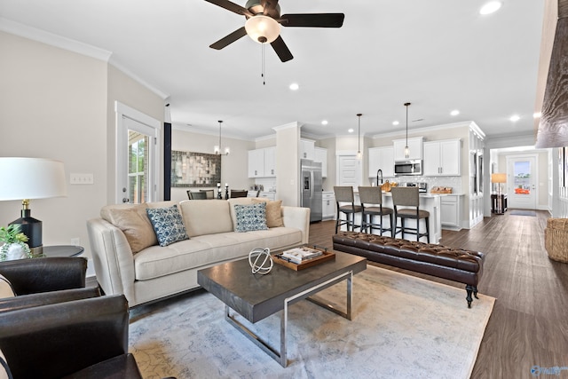 297 Keller Dr, Hazel Green, AL 35750 - living area featuring dark wood-style floors, recessed lighting, crown molding, and ceiling fan with notable chandelier