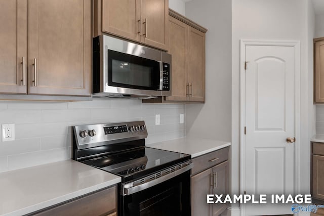 297 Keller Dr, Hazel Green, AL 35750 - kitchen with stainless steel appliances, light countertops, and backsplash