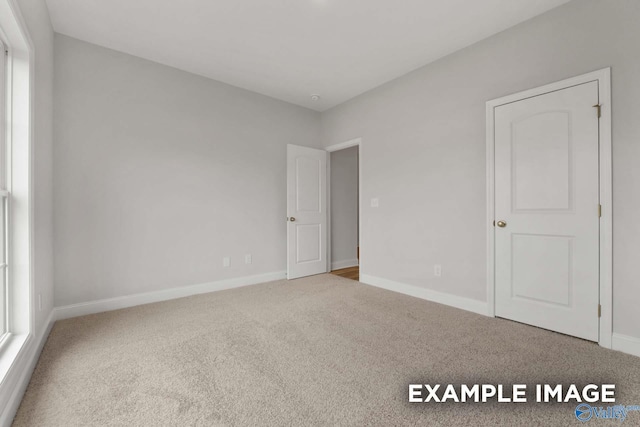 297 Keller Dr, Hazel Green, AL 35750 - unfurnished bedroom featuring carpet and baseboards