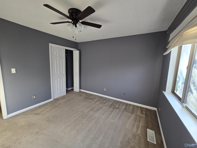 unfurnished bedroom with light carpet and ceiling fan