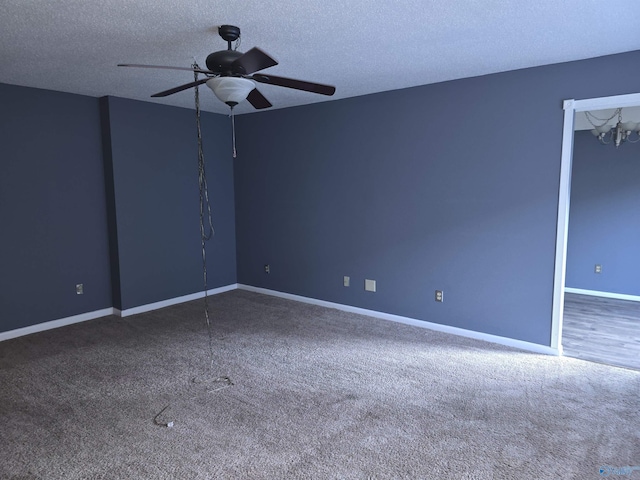 carpeted spare room featuring ceiling fan with notable chandelier and a textured ceiling