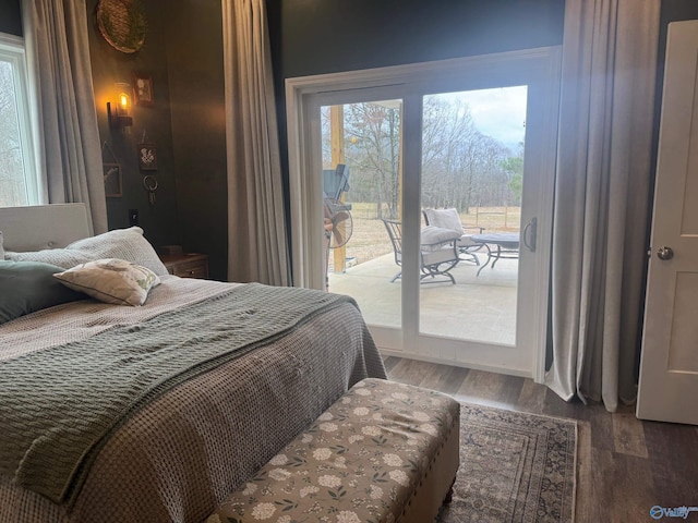 bedroom featuring dark hardwood / wood-style flooring and access to outside