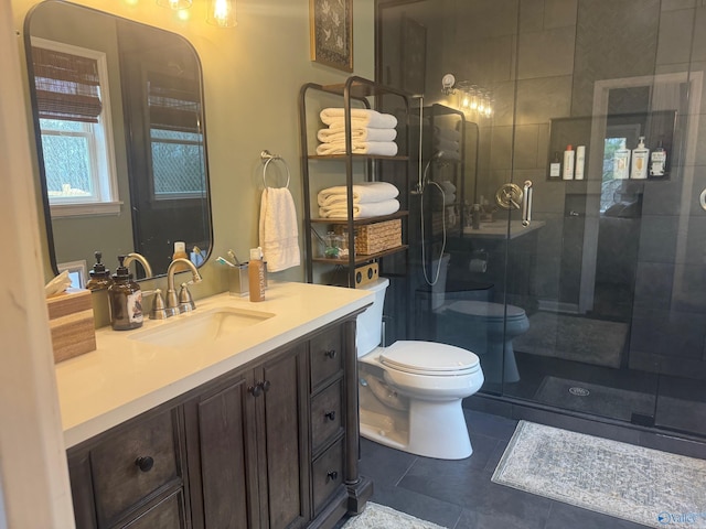 bathroom with walk in shower, vanity, tile patterned floors, and toilet